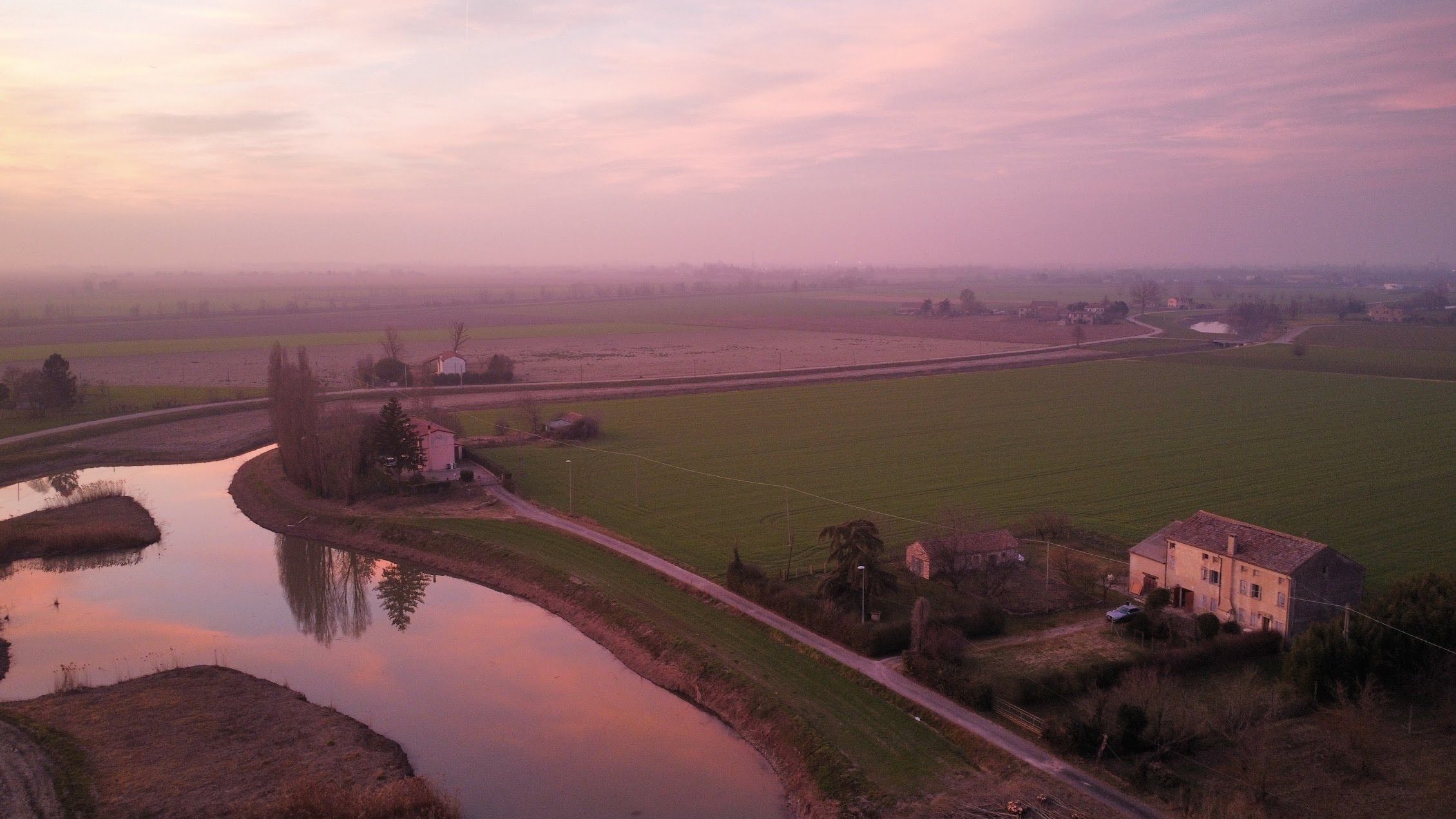 Sunset over the waterway in front of the farmhouse