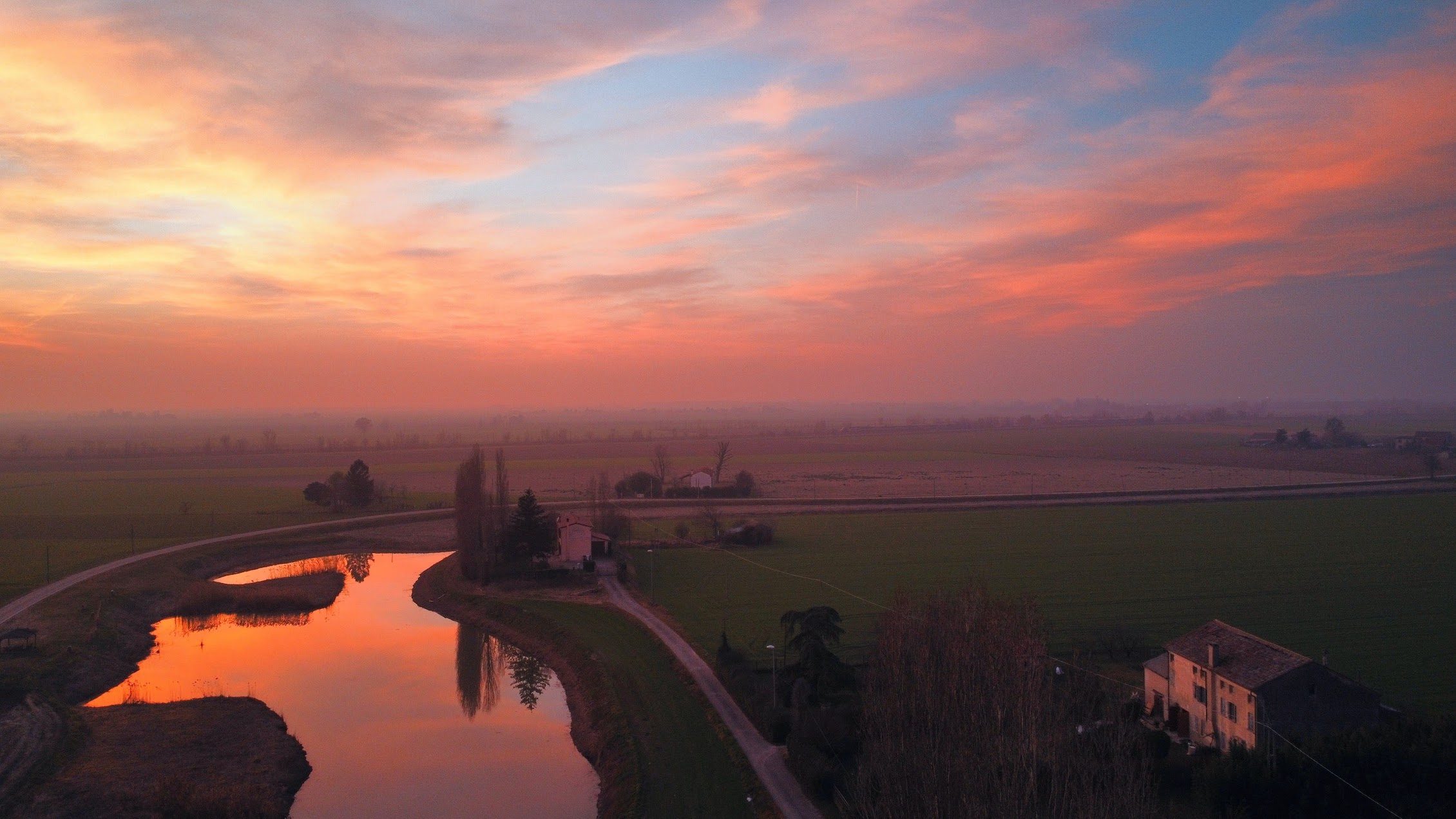Sunset over the waterway in front of the farmhouse