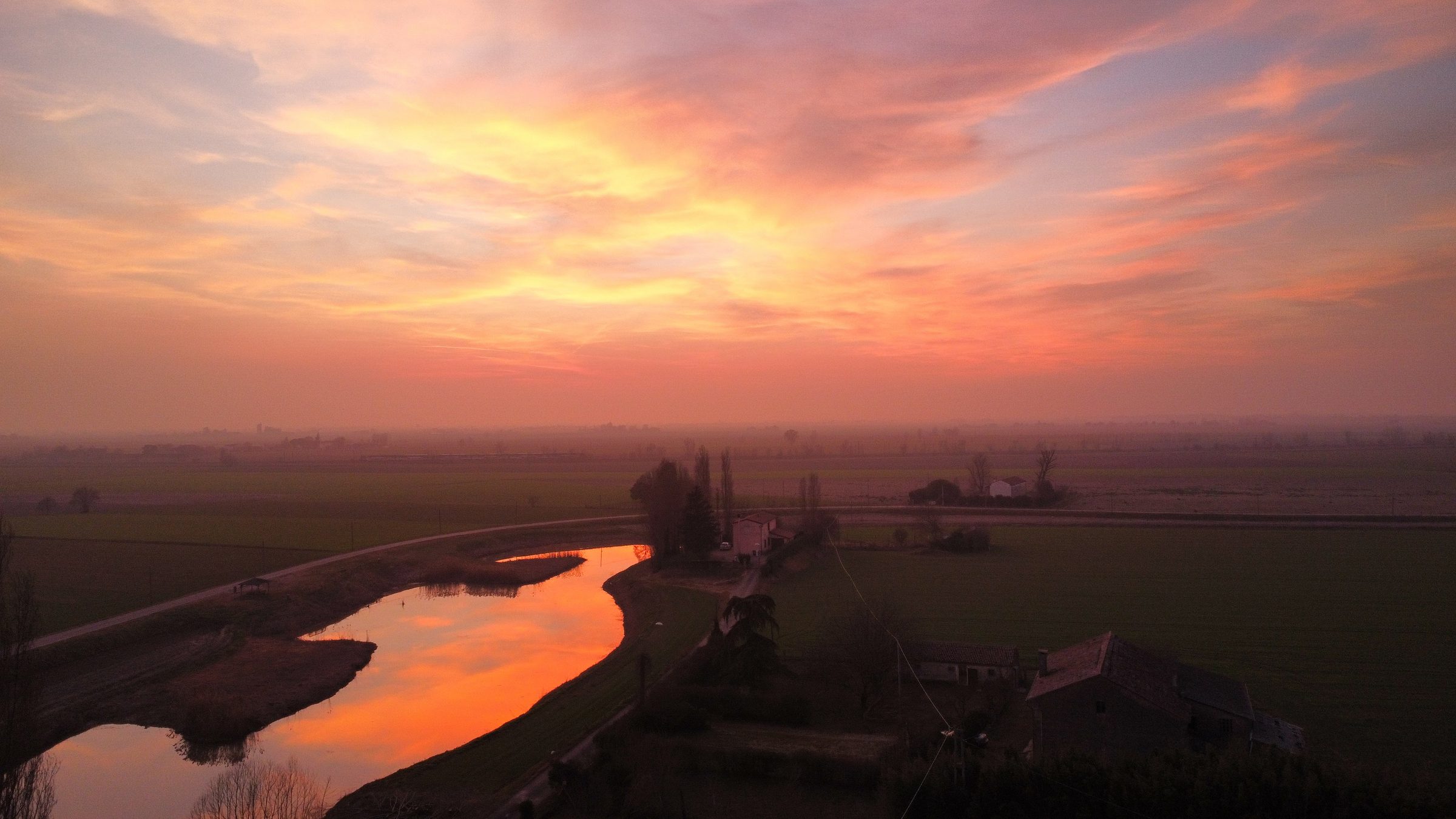 Sunset over the waterway in front of the farmhouse